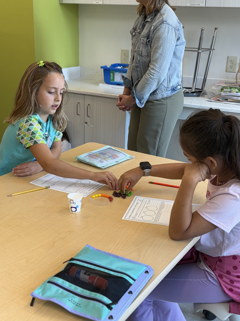 4th grade scientists observe and record skittles interacting with water in the CFIS Science lab.