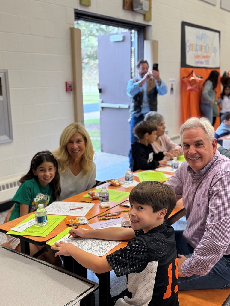 Gurney love grandparents day, students coloring and sharing a snack with loved ones.