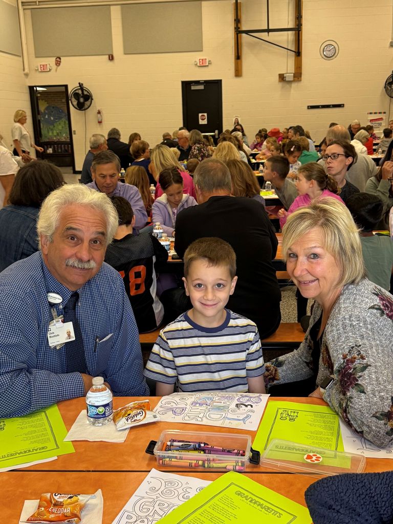 Gurney love grandparents day, students coloring and sharing a snack with loved ones.