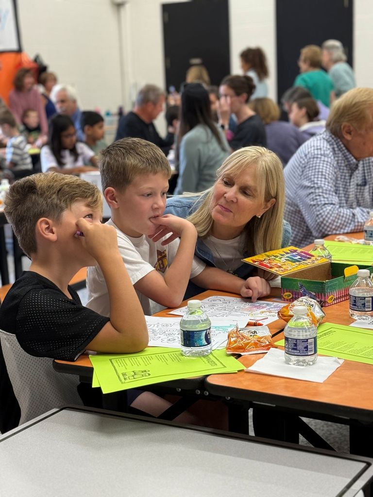 Gurney love grandparents day, students coloring and sharing a snack with loved ones.