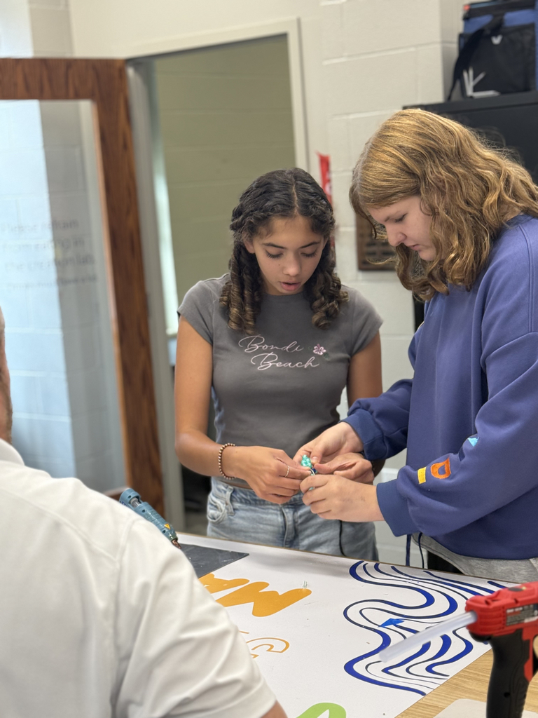 Using hot glue, students experimented with items like beads, hardware, popsicle sticks, and balloons to adjust balance and achieve neutral buoyancy.