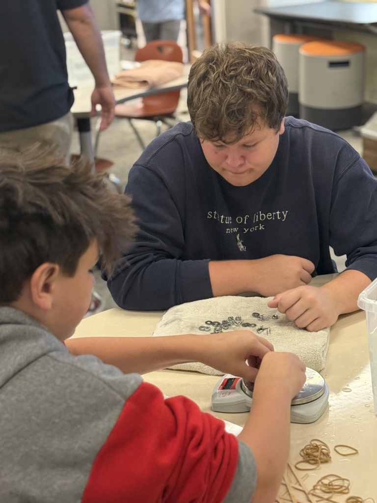 Using hot glue, students experimented with items like beads, hardware, popsicle sticks, and balloons to adjust balance and achieve neutral buoyancy.