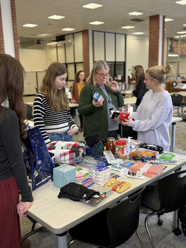 Students working together to assemble bags to give to those in need.