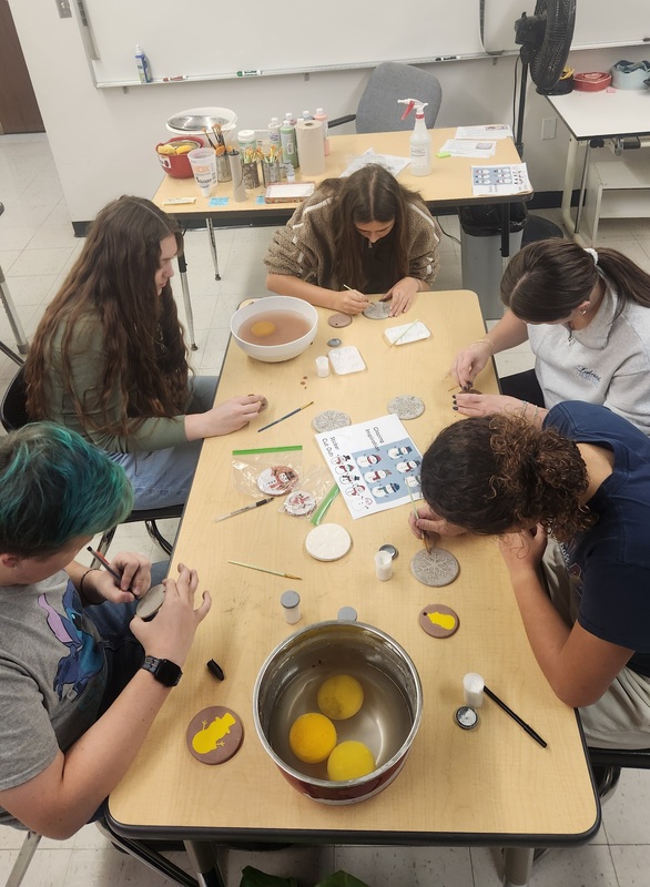 Students working together to assemble bags to give to those in need.
