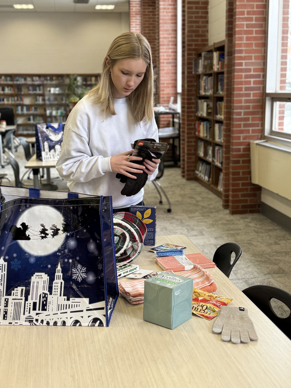 Students working together to assemble bags to give to those in need.