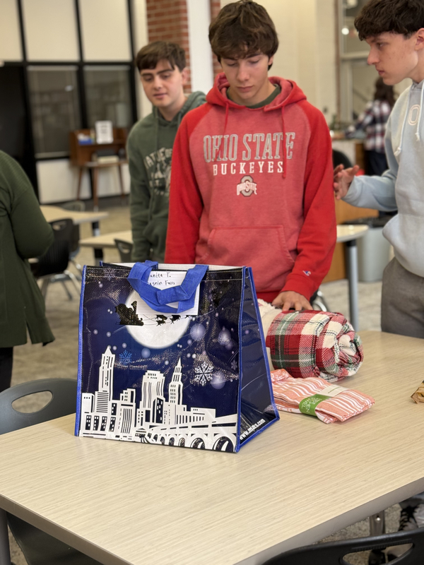 Students working together to assemble bags to give to those in need.
