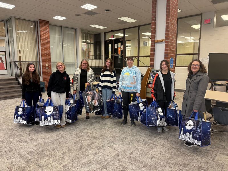 Students working together to assemble bags to give to those in need.