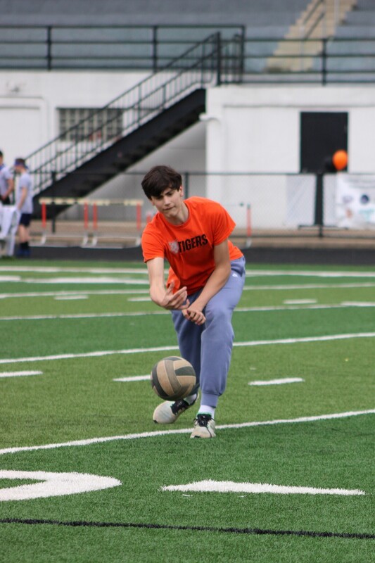 8th grade kick it for cancer game, students cheering eachother on and playing kickball