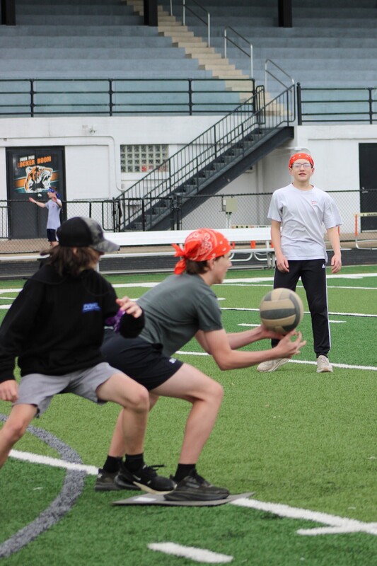 8th grade kick it for cancer game, students cheering eachother on and playing kickball