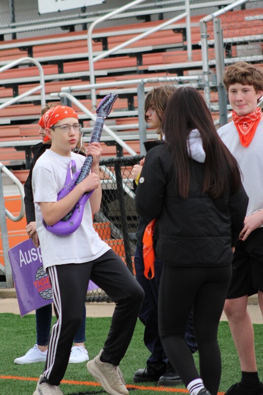 8th grade kick it for cancer game, students cheering eachother on and playing kickball
