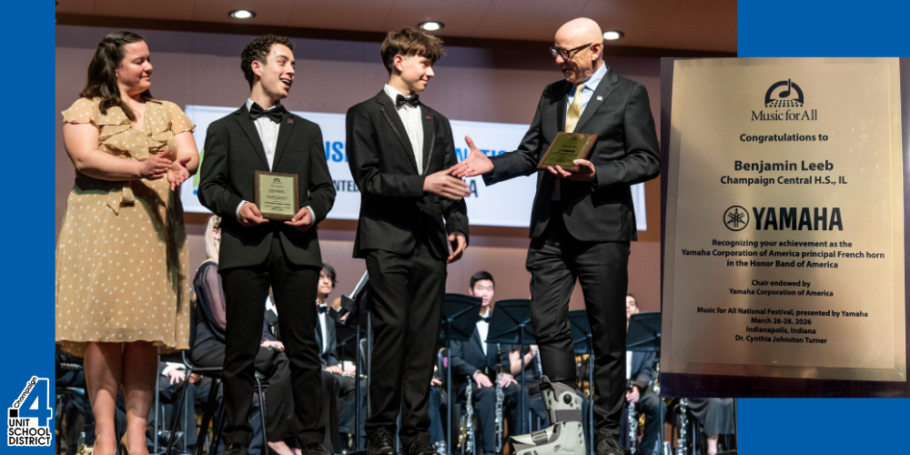 Three award winners on stage, one holding a plaque. One man in a suit presents a plaque.