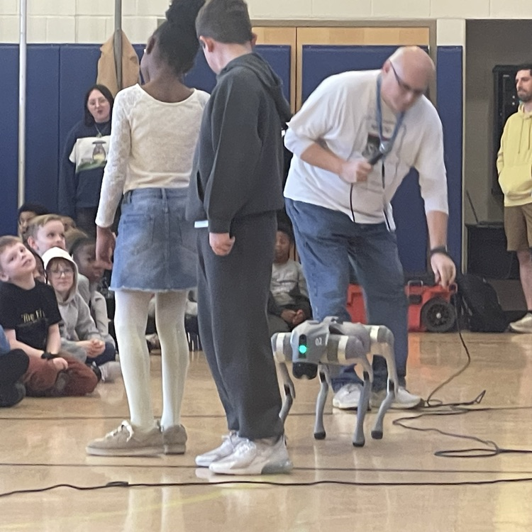 Bottenfield students and a teacher with a robotic dog