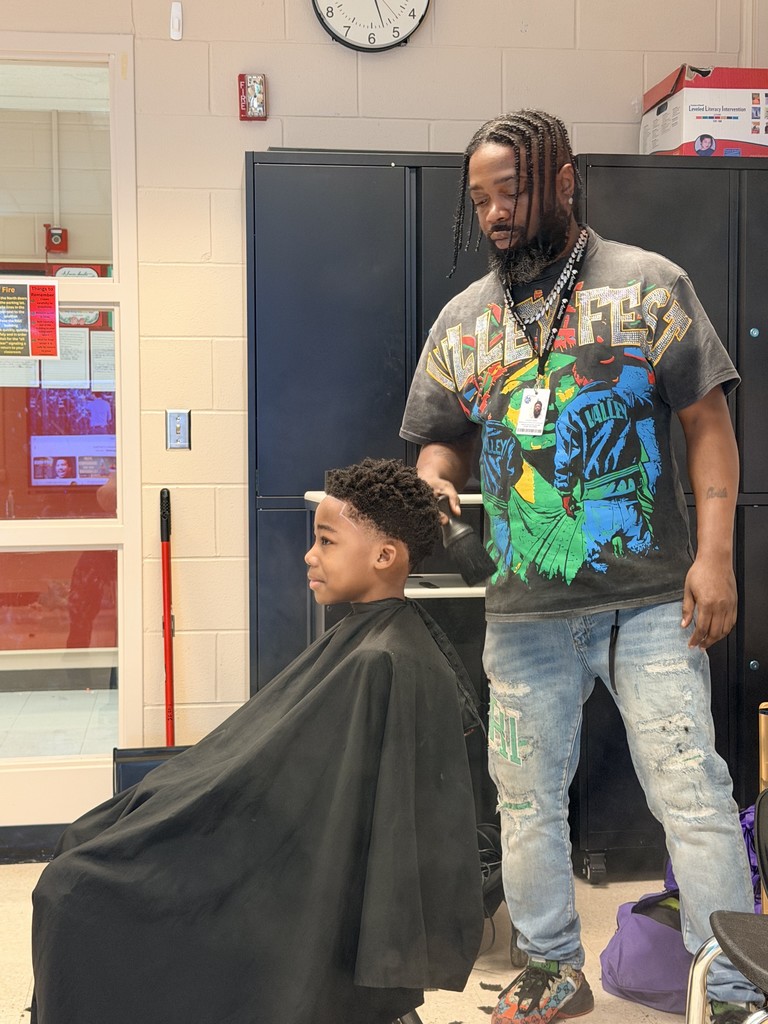 Student receives a free haircut for NAAPID at Stratton