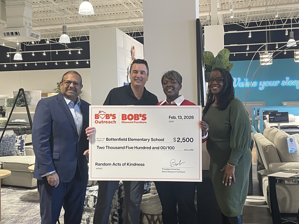 Bottenfield Principal Kendra Bonam recieving a $2,500 check from Bob's Discount Furniture in Champaign along side Bob's corporate ambassador, regional manager and manager.