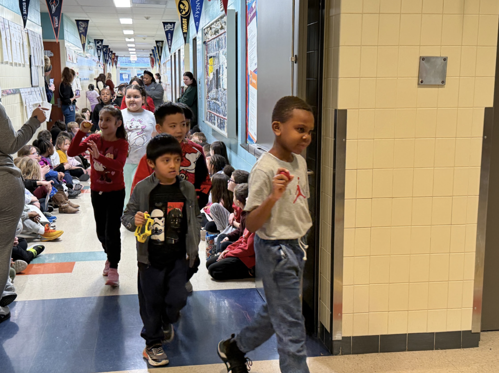 Students watching the end of the parade while students walk past celebrating the lunar new year