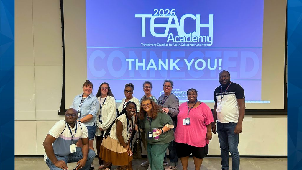 Group of people smiling in front of a projection screen with "2026 Teach Academy" and "Thank You!" displayed.