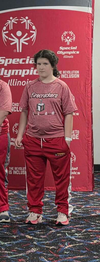 A Unit 4 student poses for a photo at the Special Olympics.
