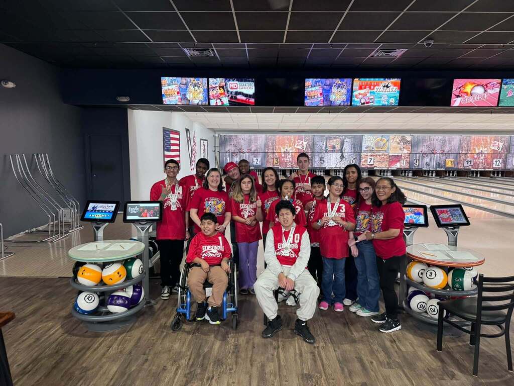Edison Special Olympic bowling team pictured in red shirts at a competition in Danville, Illinois.