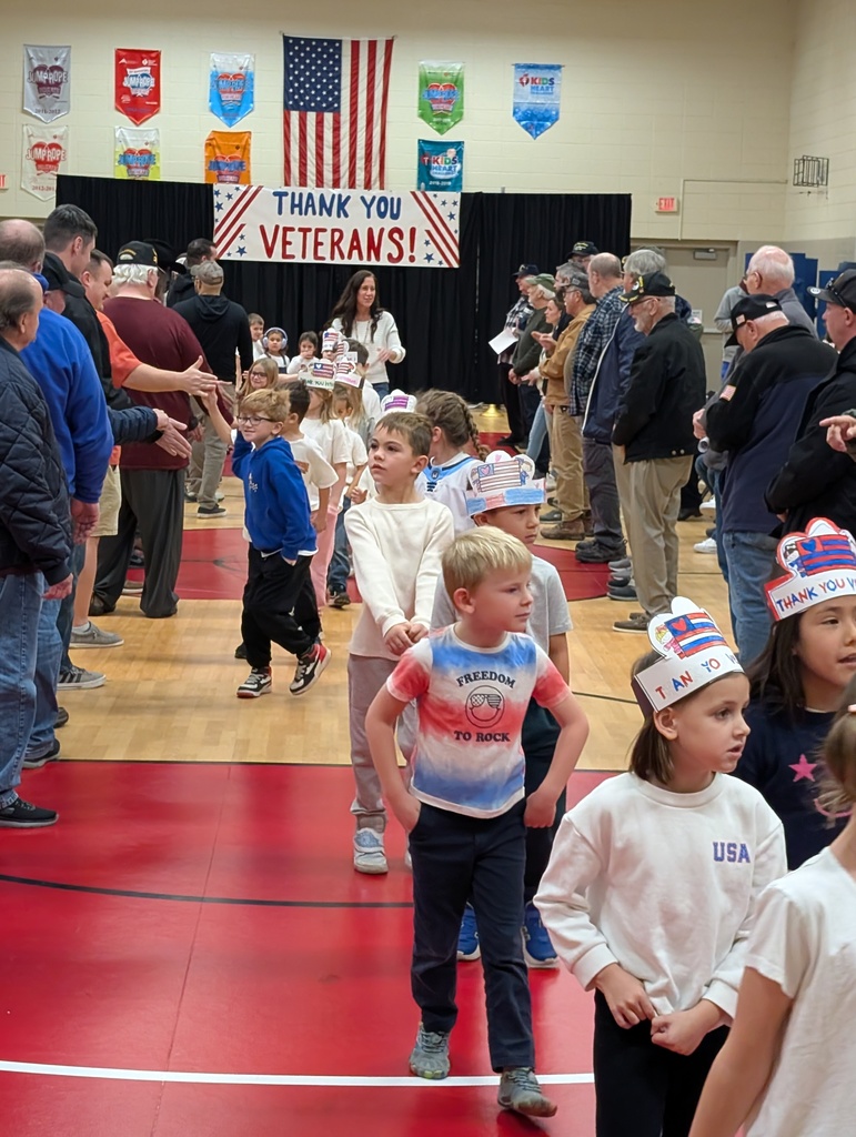 students shaking hands with veterans
