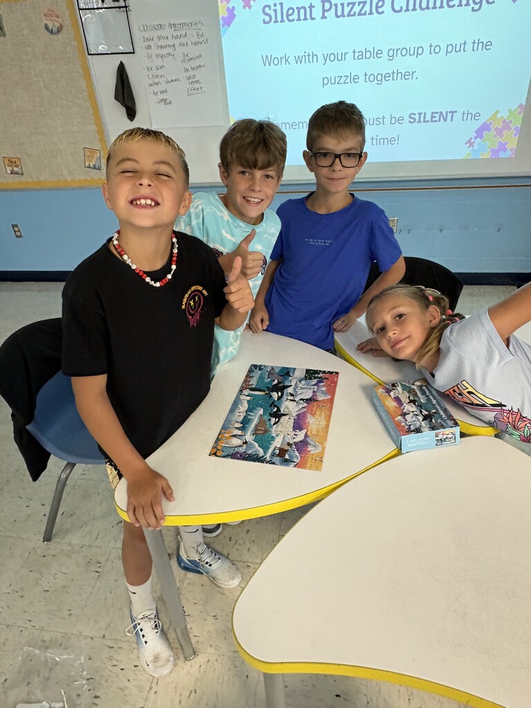 Students with completed puzzle