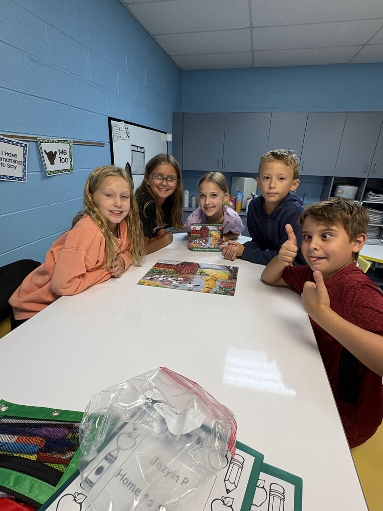 Students with completed puzzle
