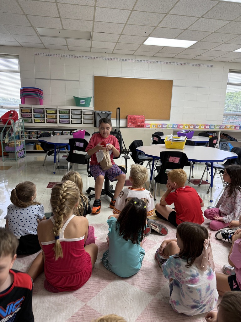 STUDENT SHOWING CLASS FAVORITE ITEMS