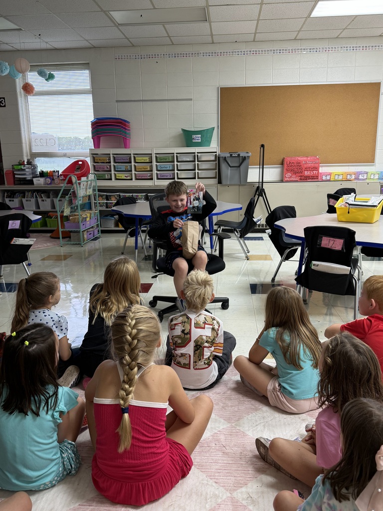 STUDENT SHOWING CLASS FAVORITE ITEMS