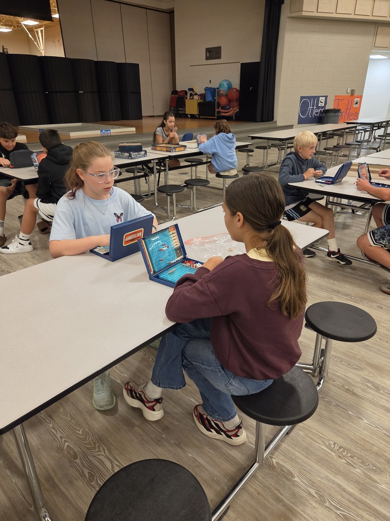 Students playing battleship at table