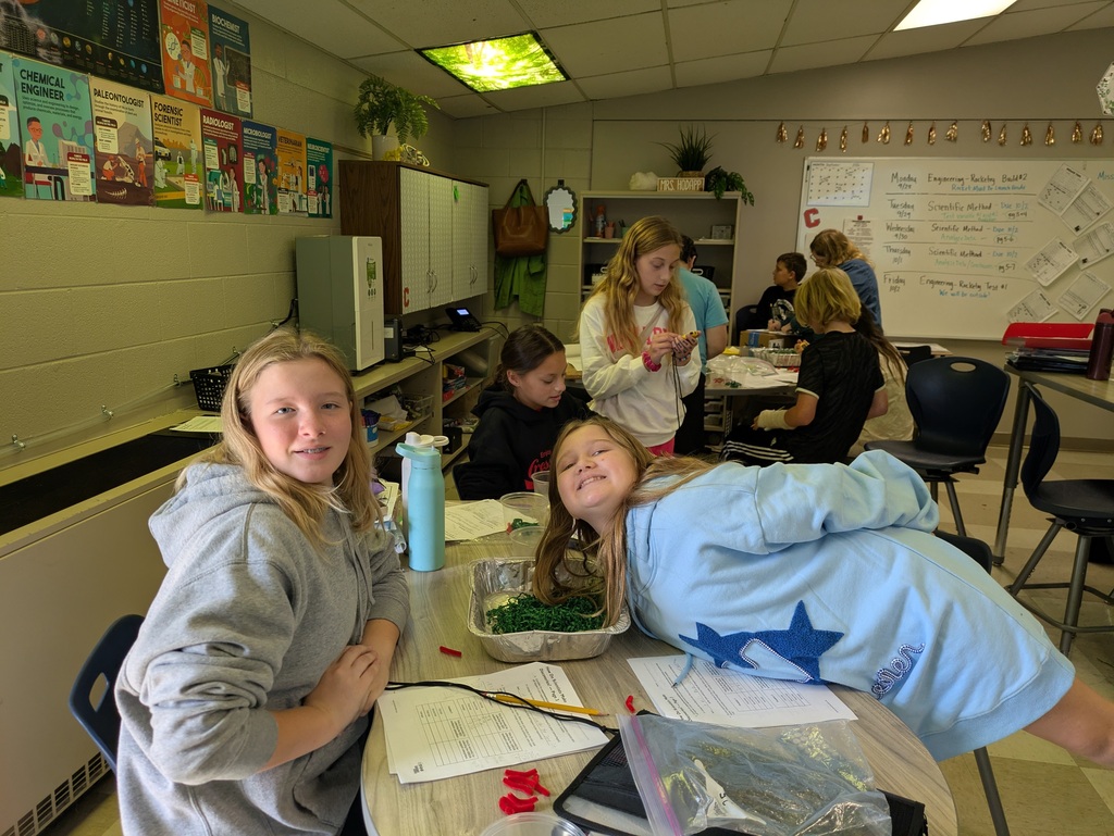 Students working a desk on science project