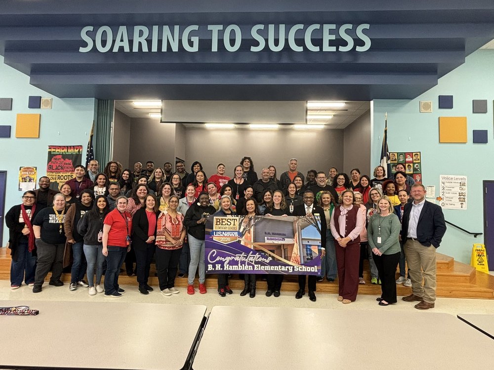 Hamblen Ele mentary staff stands on the cafeteria stage