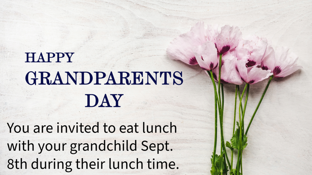 A spray of flowers sits on a bleached wooden background. Words on the left read: Happy Grandparents Day/ You are invited to each lunch with your grandchild Sept. 8th during their lunch time.