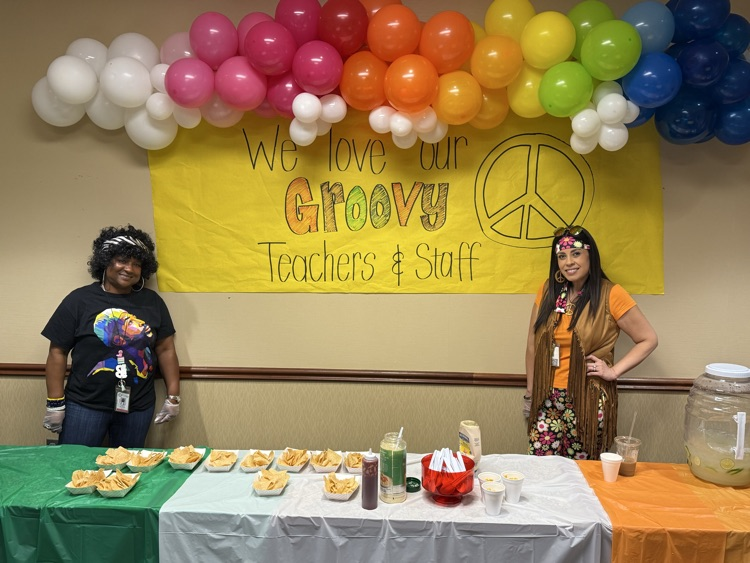 teachers serving nachos for 70s day