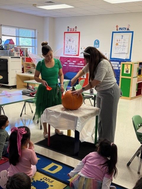 Teachers and students carving pumpkin