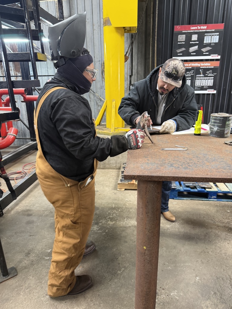 Welding teacher and student