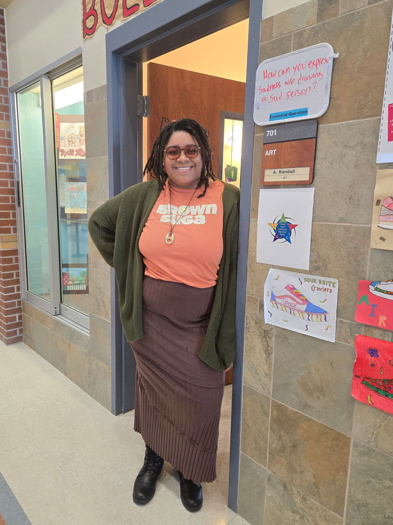 art teacher wearing glasses and an outfit in theme with melanin monday