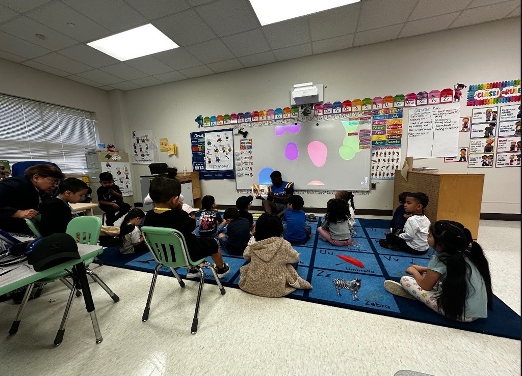 Channelview HS Football Players reading to ECC Pre-K Students for Dr. Seuss Week