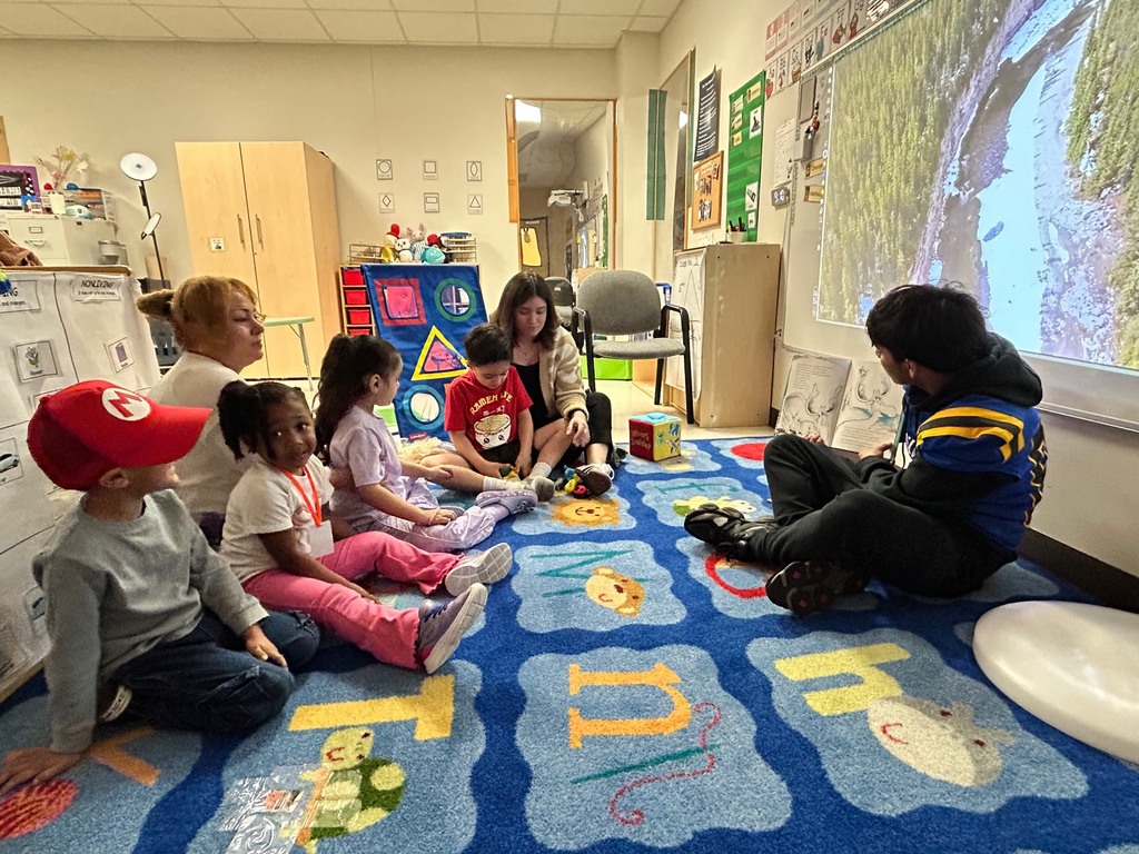 Channelview HS Football Players reading to ECC Pre-K Students for Dr. Seuss Week