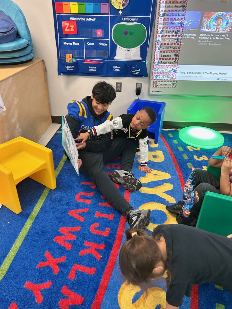 Channelview HS Football Players reading to ECC Pre-K Students for Dr. Seuss Week