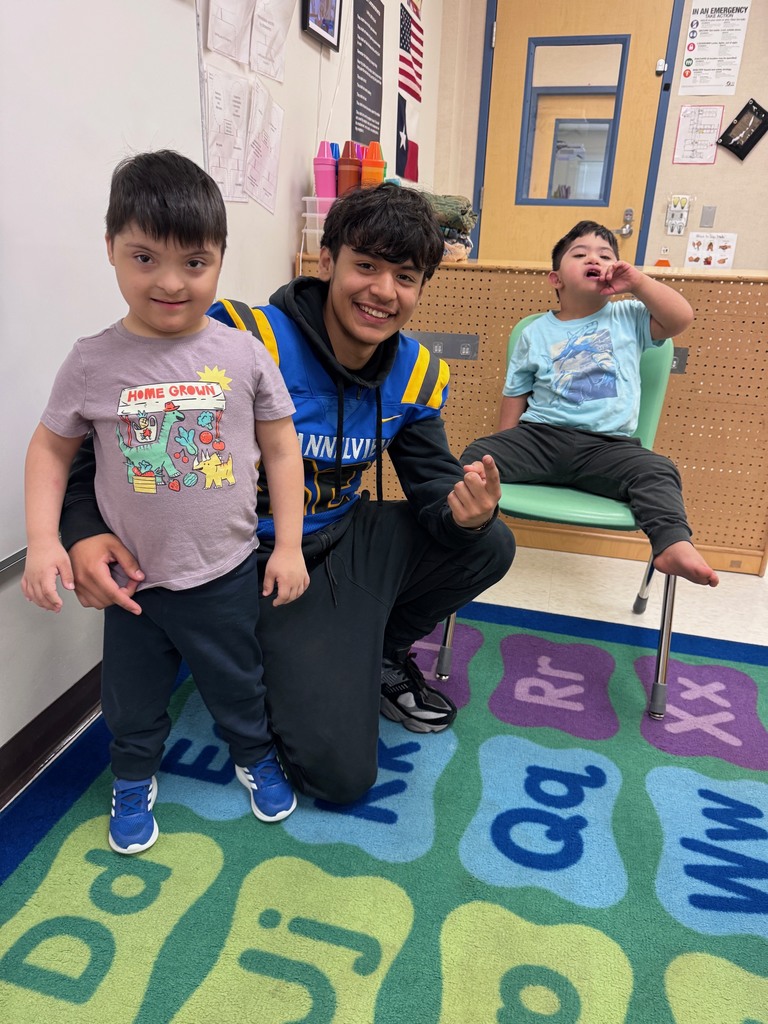 Channelview HS Football Players reading to ECC Pre-K Students for Dr. Seuss Week