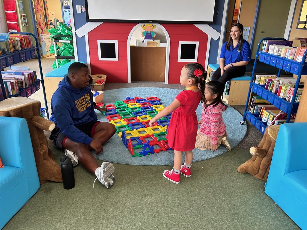 Channelview HS Football Players reading to ECC Pre-K Students for Dr. Seuss Week