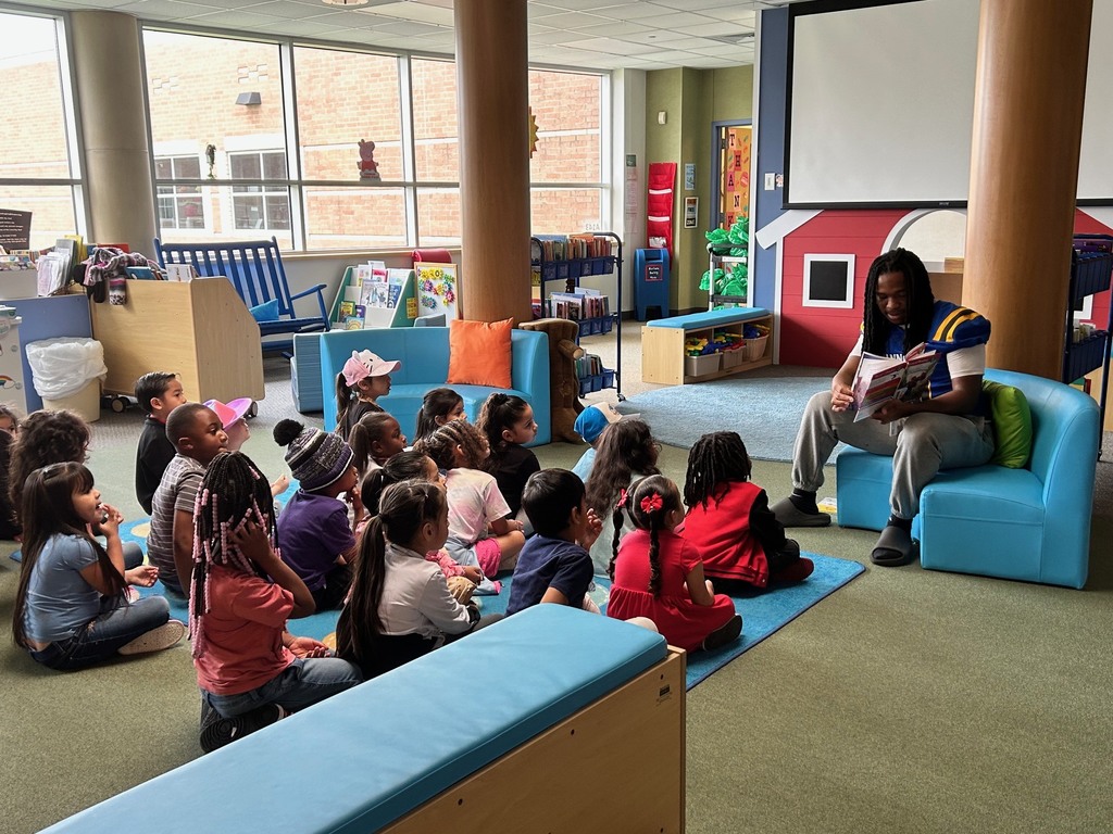 Channelview HS Football Players reading to ECC Pre-K Students for Dr. Seuss Week