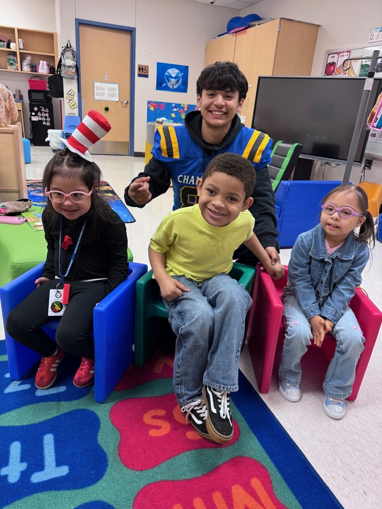 Channelview HS Football Players reading to ECC Pre-K Students for Dr. Seuss Week