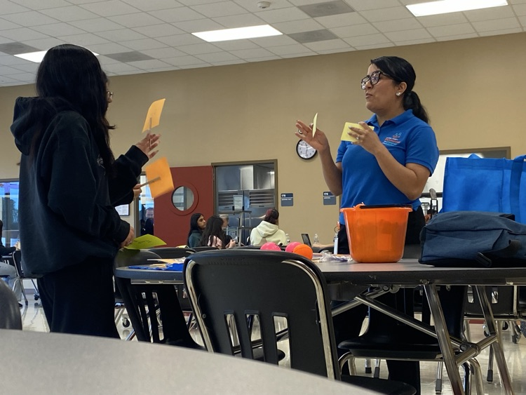 CYS worker plying a card game