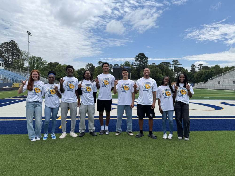 9 Chapel Hill ISD track and field students hold up the CH hand sign in preparation to attend the 2026 state UIL competition