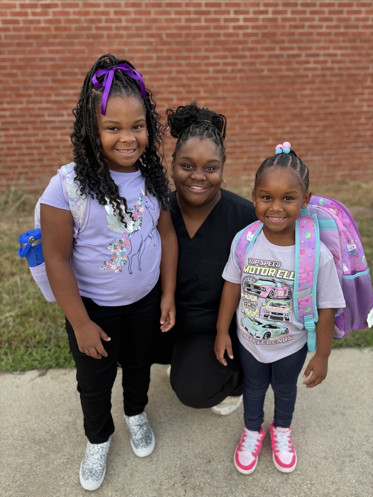 A mom and two daughters on the first day of school