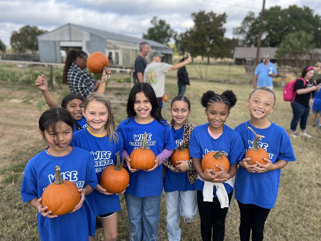 students holding pumpkins