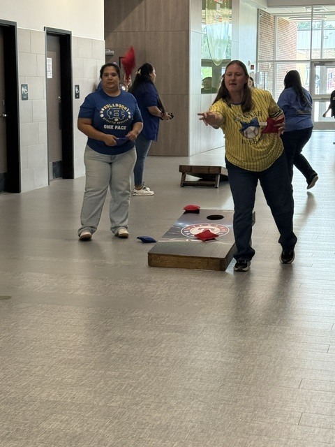 ladies in a cornhole tournament