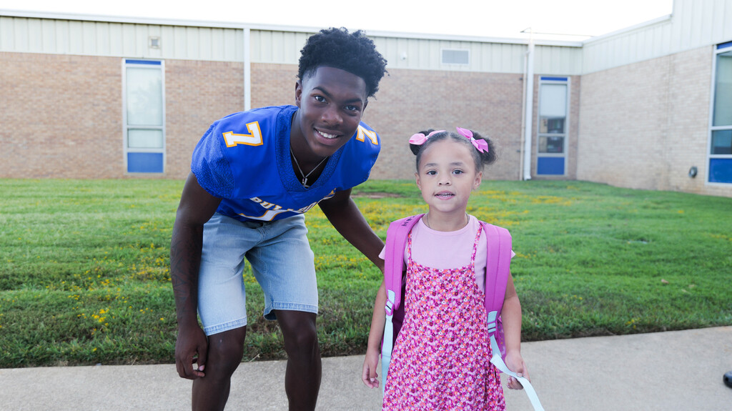 a football player and a pre-k student
