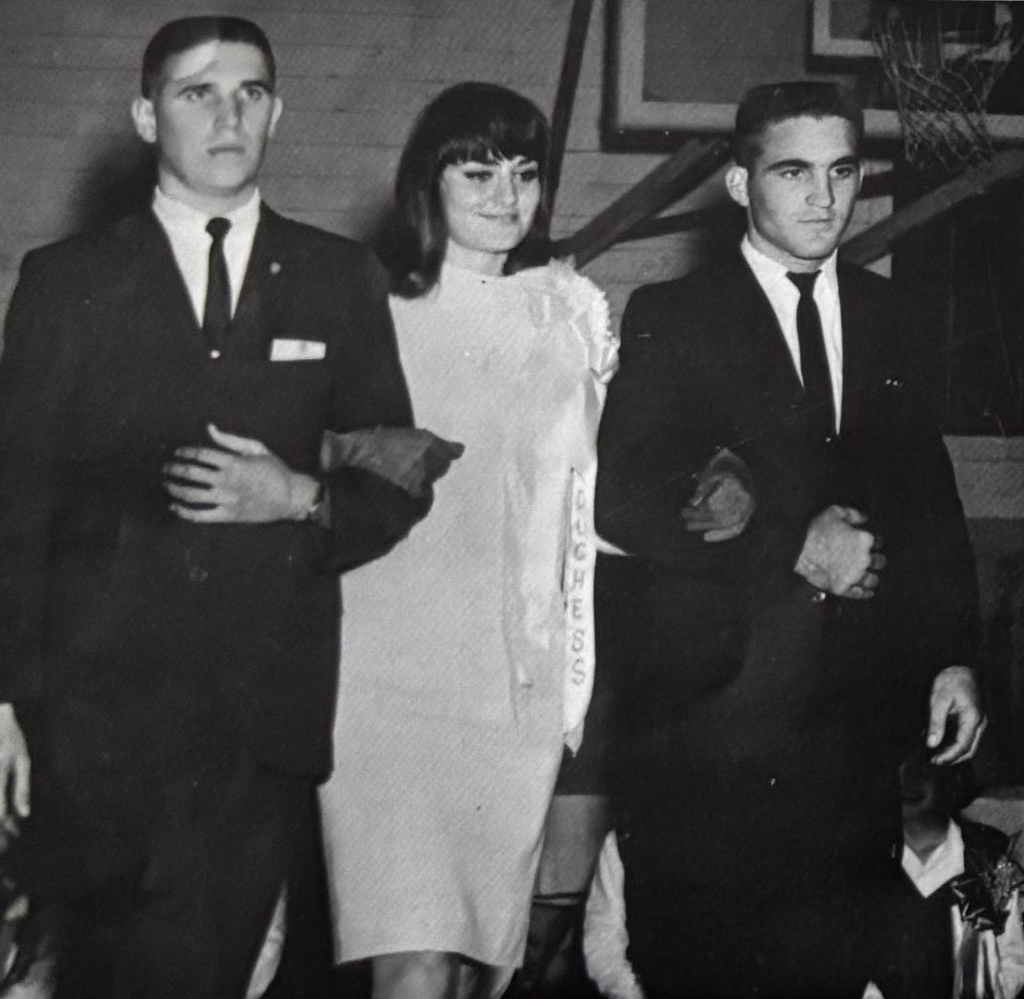 two guys walking a girl inside