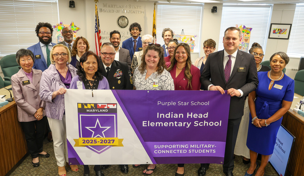 group of educators behind banner for purple star
